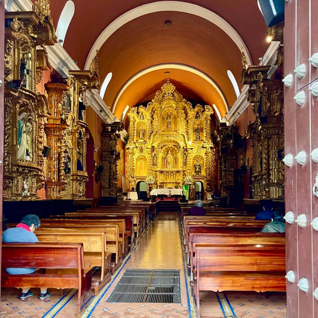 Looking through the door of Santa María Magdalena in Pueblo Libre and noticing the catacombs through the floor