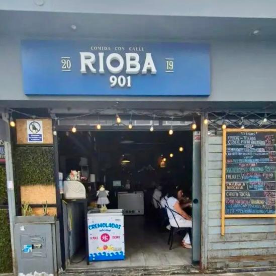 Exterior view of Rioba 901 restaurant in Pueblo Libre, Lima, showing the storefront and menu board.